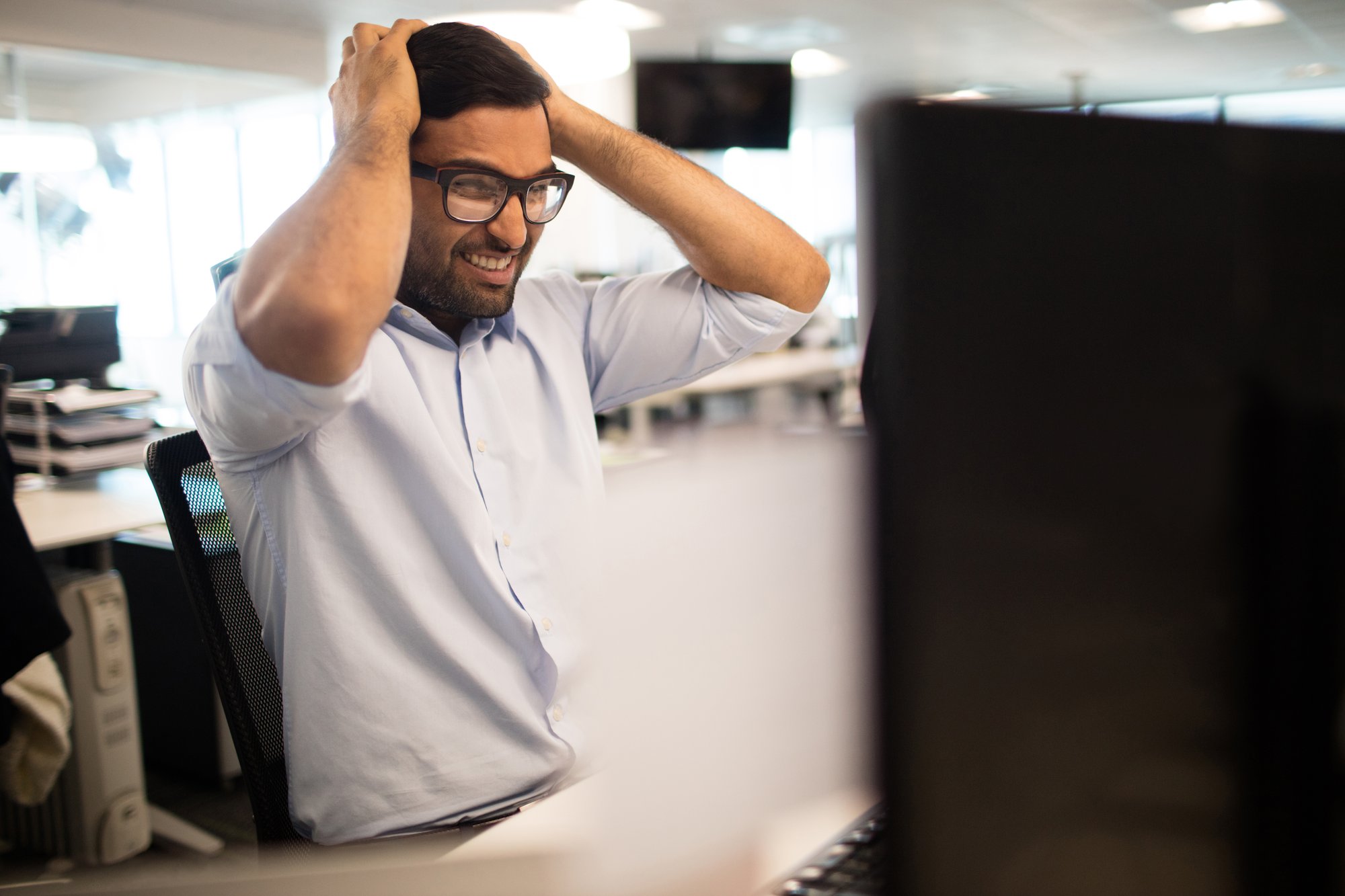 tensed-businessman-clenching-teeth-office